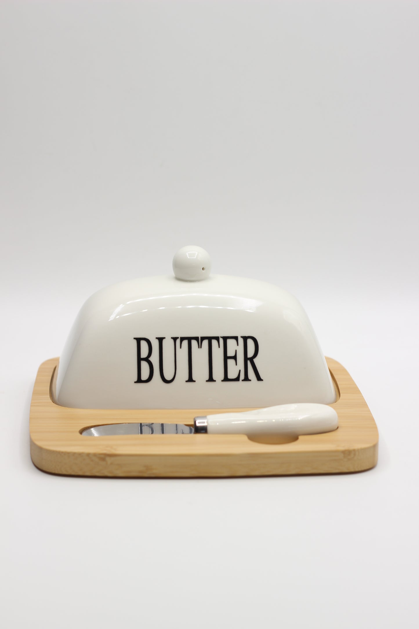 Butter and cheese plate with wooden base, knife and glass lid